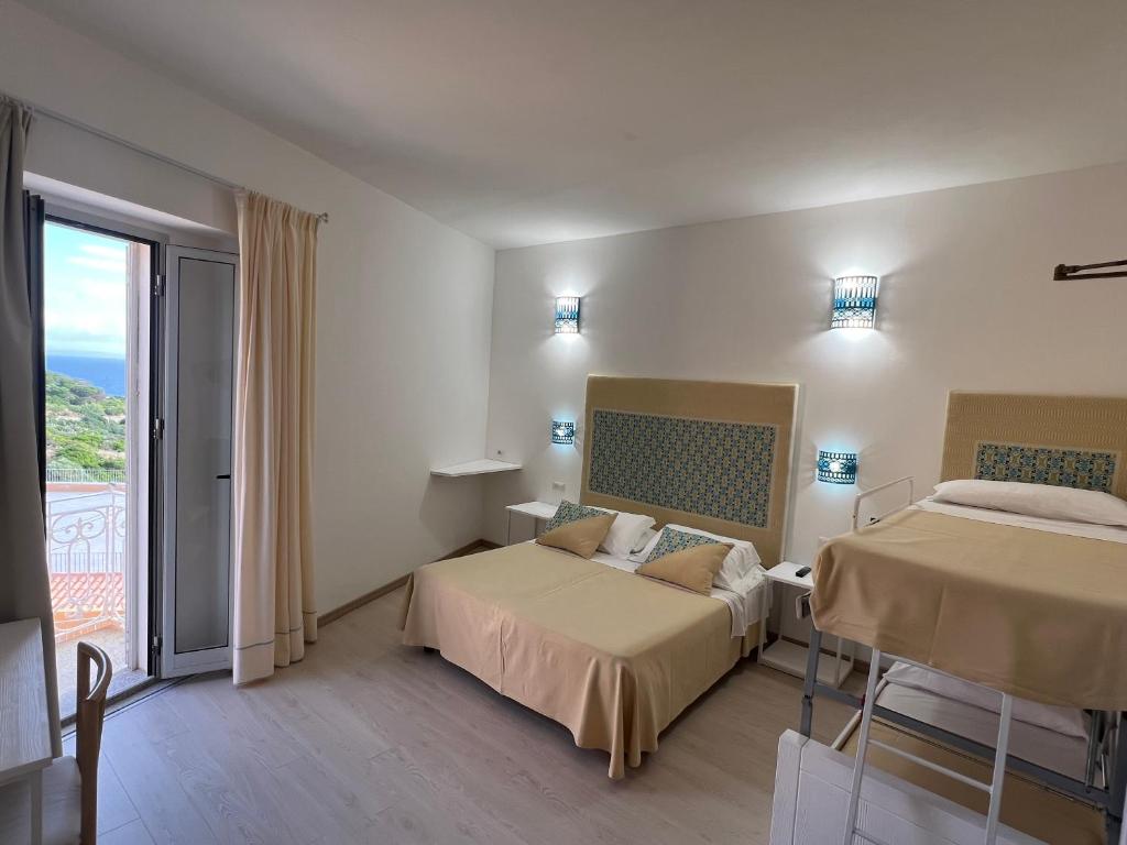 Postel nebo postele na pokoji v ubytování Hotel Da Cecco