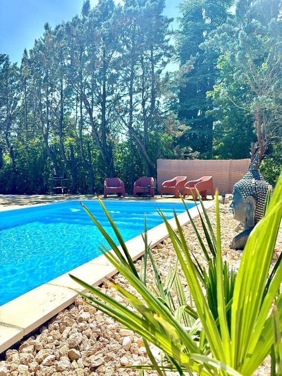 - une piscine dans une cour avec des chaises à côté dans l'établissement La vill'ona, à Grospierres