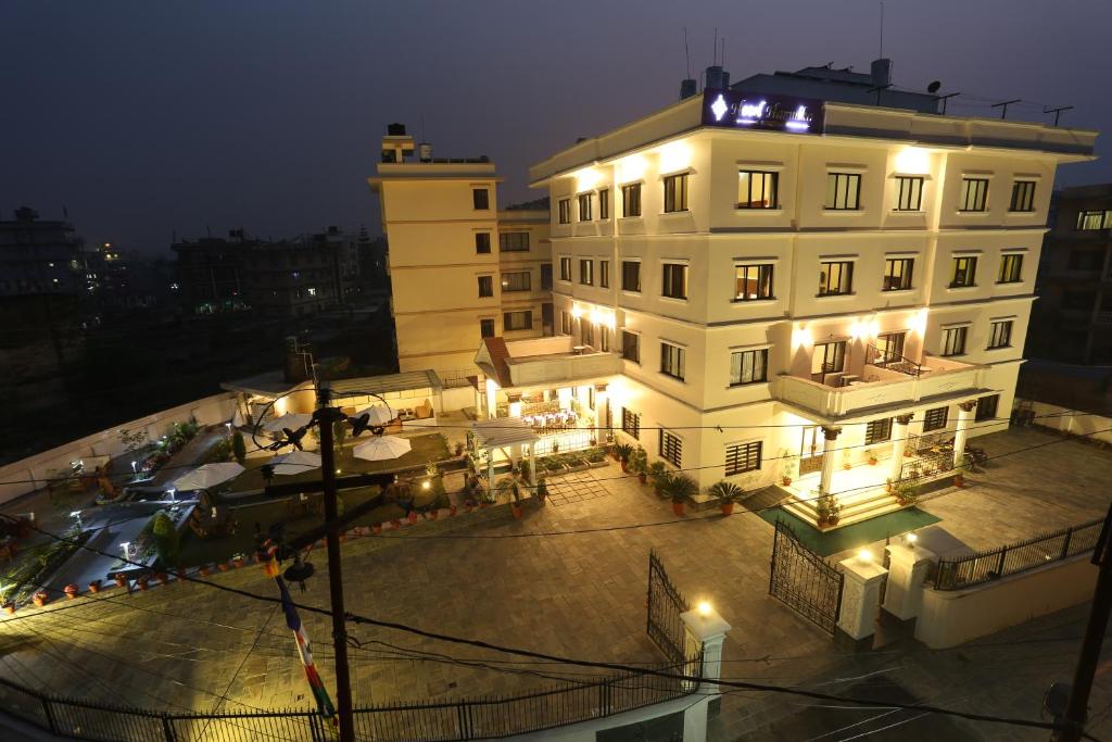 a large white building with lights on it at night at Hotel Harmika in Kathmandu