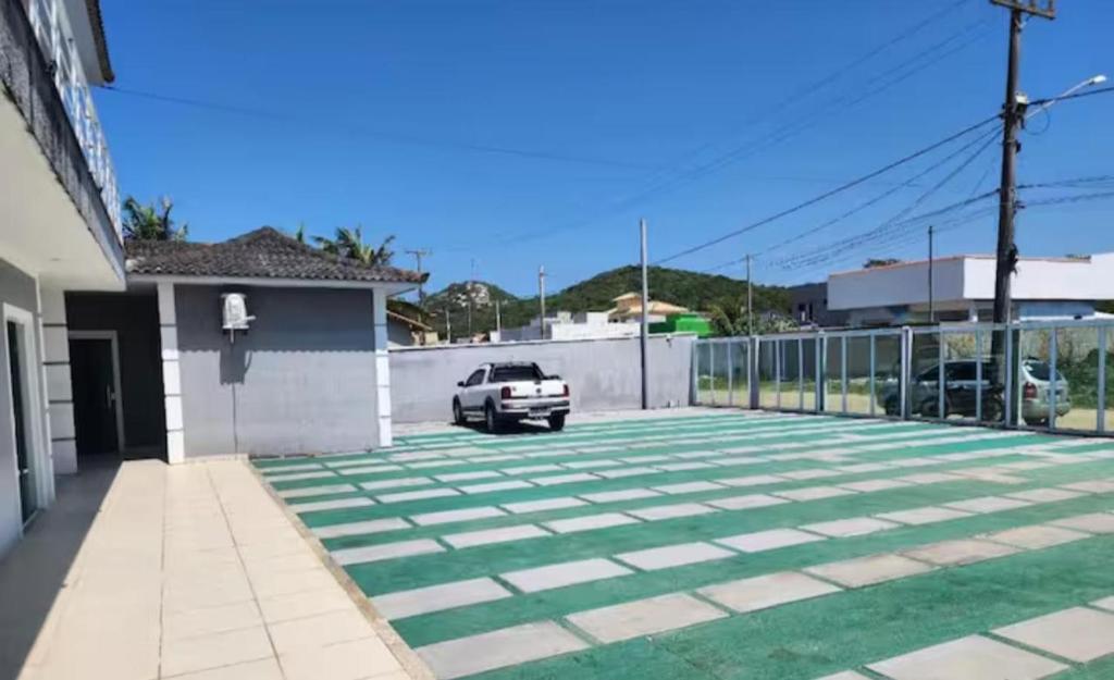 a car parked in a driveway of a house at Suite Dunas do Peró in Cabo Frio