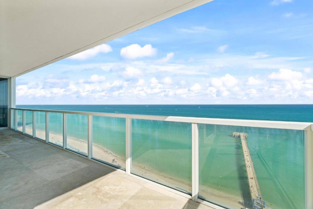 a view of the ocean from the balcony of a condo at Luxurious 2BD Condo with Direct Ocean Front & Resort Pool in Sunny Isles in Sunny Isles