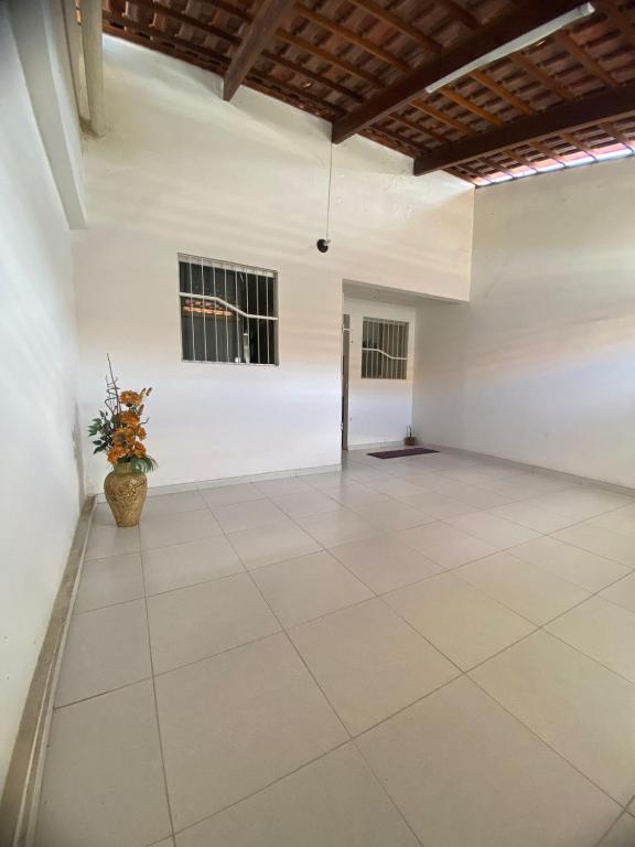 a large room with white walls and a wooden ceiling at Casa Bella Temporada in Campina Grande