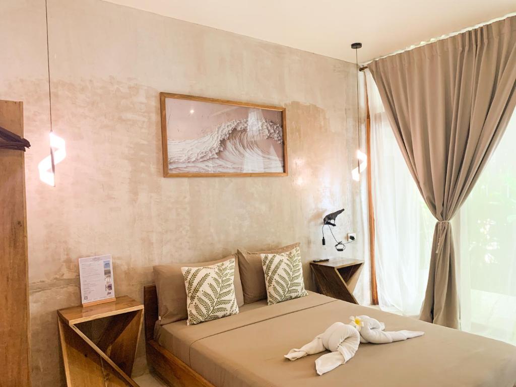 Una cama o camas en una habitación de Moringa Inn