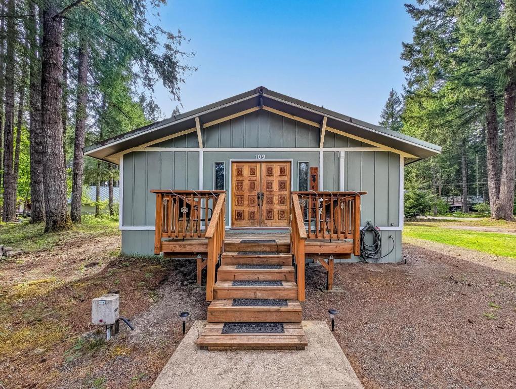 a house with wooden steps leading up to the front door at Peak View | White Pass, Mt Rainier in Packwood
