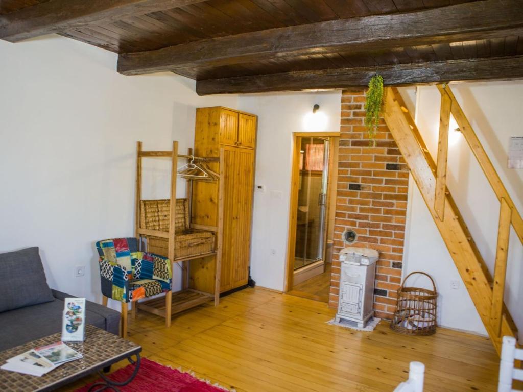 a living room with wooden floors and a brick wall at Holiday Home MILa - Duplex one bedroom Holiday Home with Terrace in Stubicke Toplice