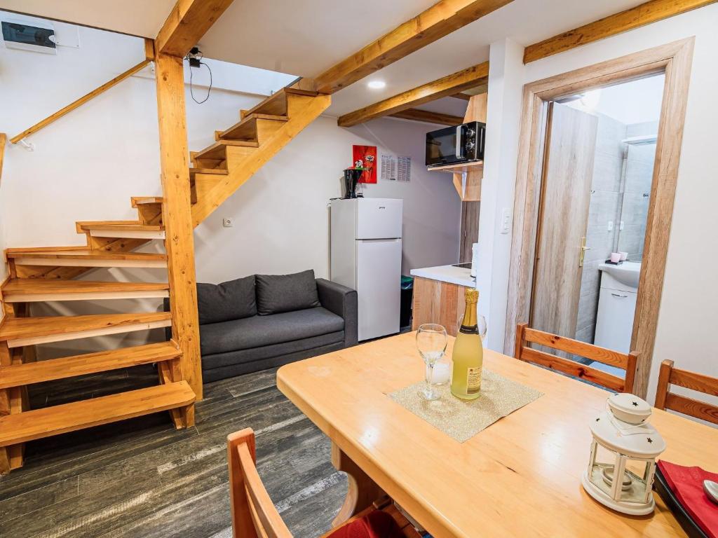 a kitchen and living room with a wooden table and a stairs at Sleek and Stylish Umag Apartments with Sea View - Comfort Two Bedroom Apartment with Terrace in Umag