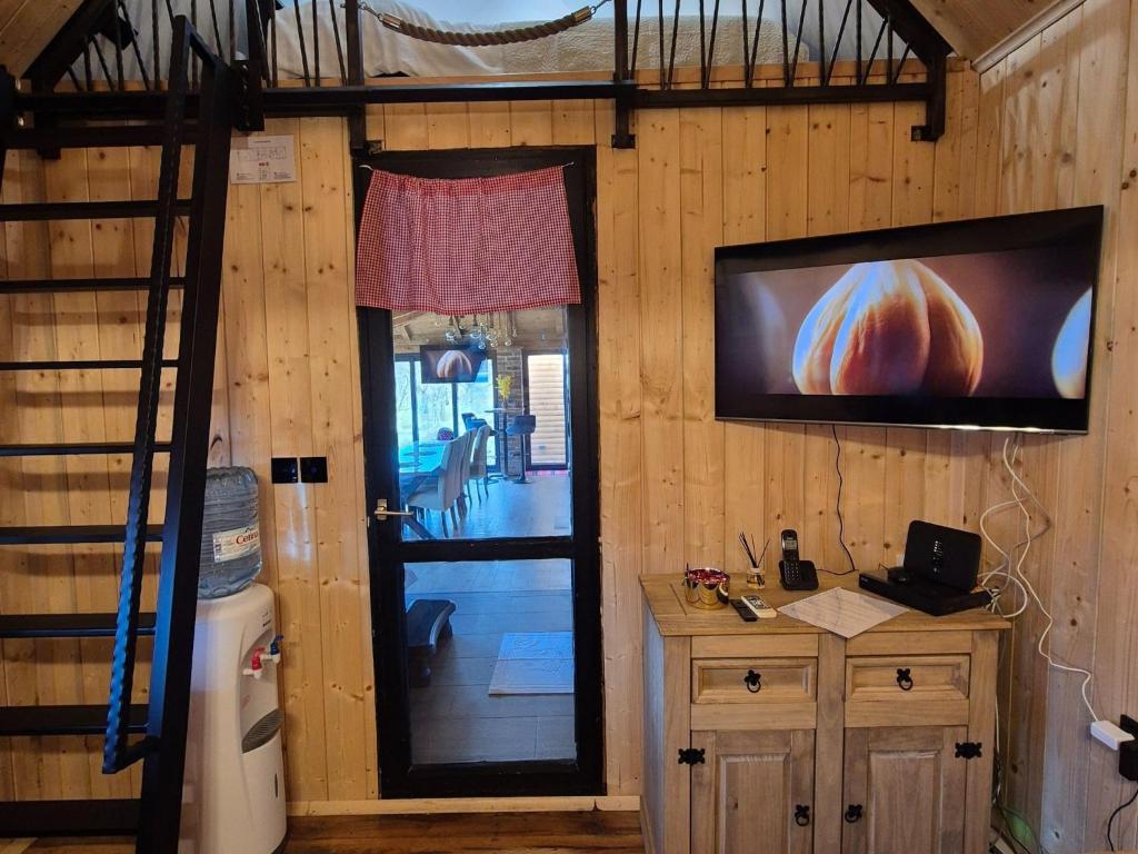 a room with a television on a wall with a door at Holiday Home Ana - Holiday Home in Brežane Lekeničke