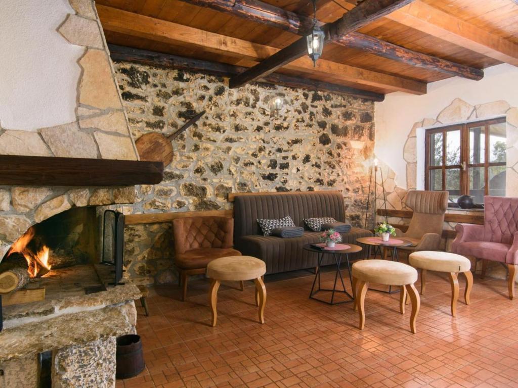 a living room with a fireplace and a couch at Vila Ive winter spa Podumci in Podumci