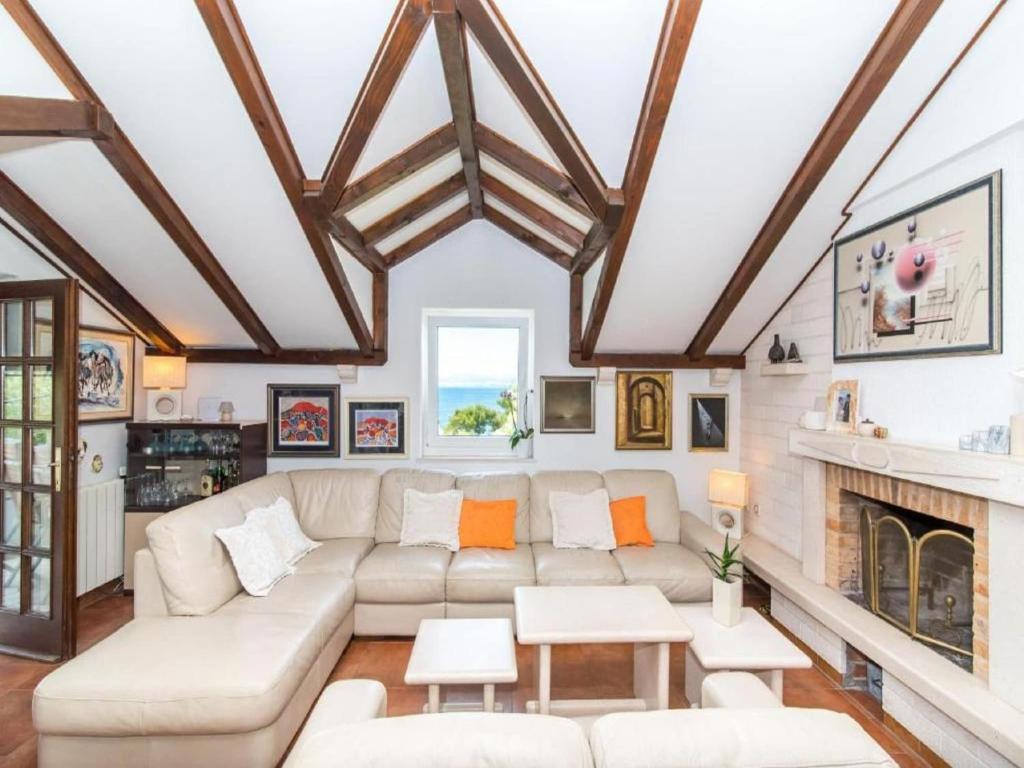 a living room with a couch and a fireplace at Three bedroom Apartment with terrace and sea view in Postira