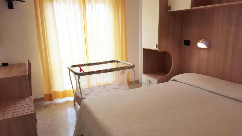 Postel nebo postele na pokoji v ubytování Hotel Trocadero