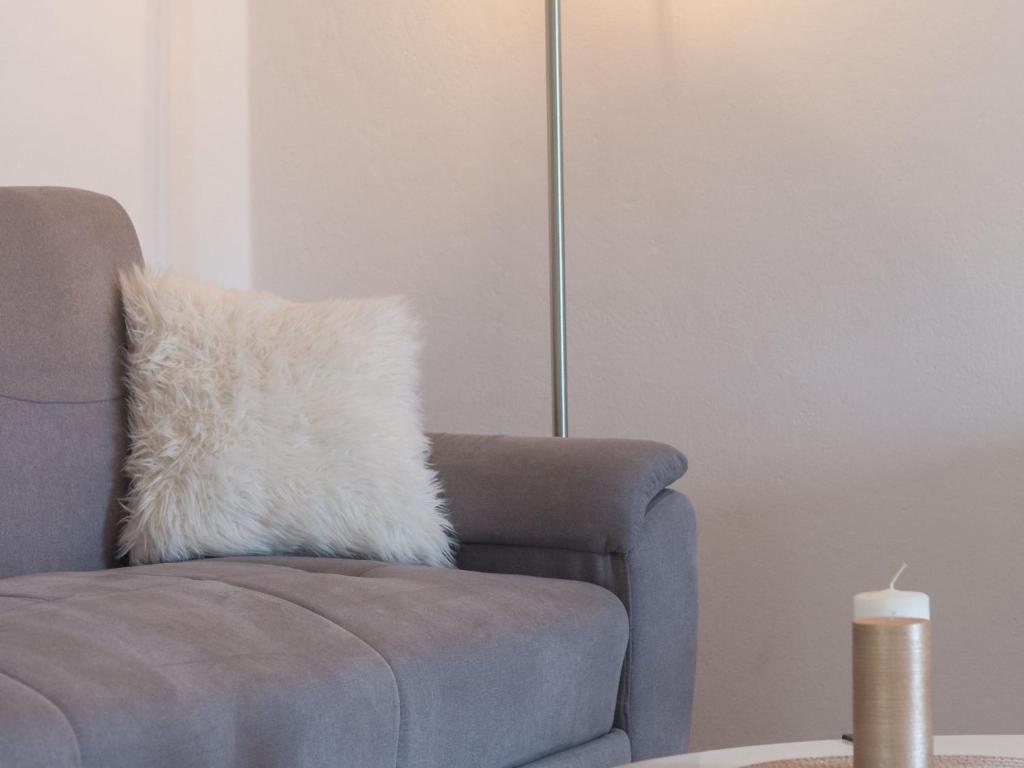 a pillow on a chair in a living room at Four Bedroom Holiday Home with Sea View in Ston