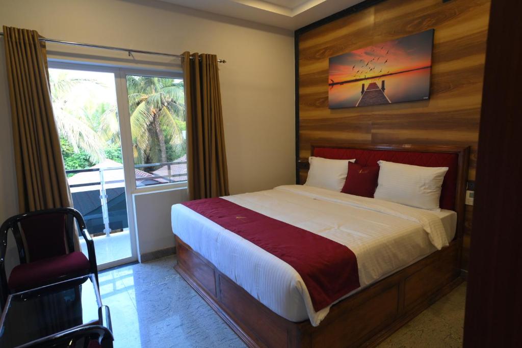 Postel nebo postele na pokoji v ubytování Hotel Ramraj Regency