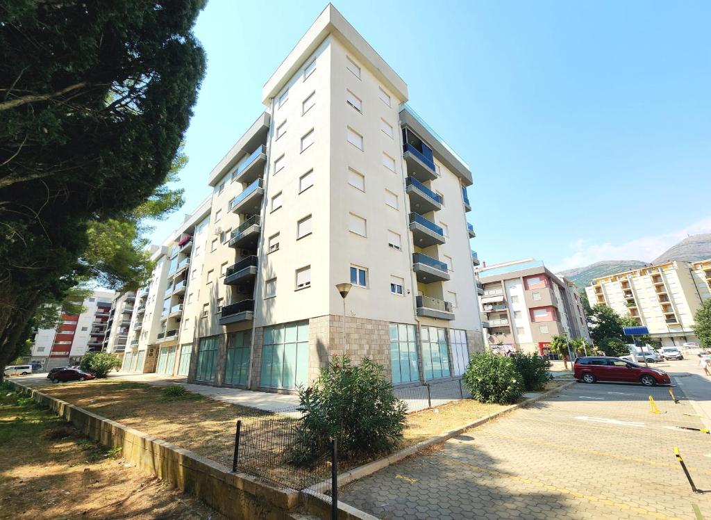 a tall white building on a city street at Apartment Bella Vista in Trebinje