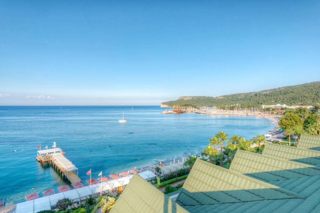 a view of a beach with a dock in the water at Golden Lotus Hotel in Kemer