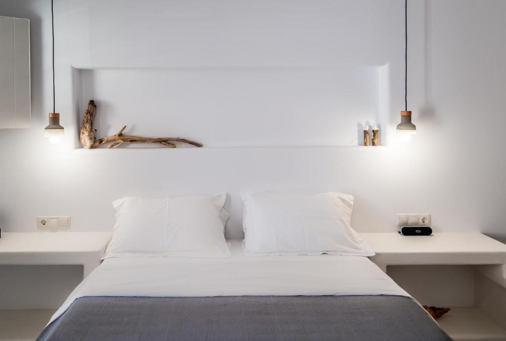 Postel nebo postele na pokoji v ubytování Vilos Suites