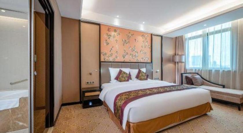 Postel nebo postele na pokoji v ubytování Nanning Yongjiang Hotel