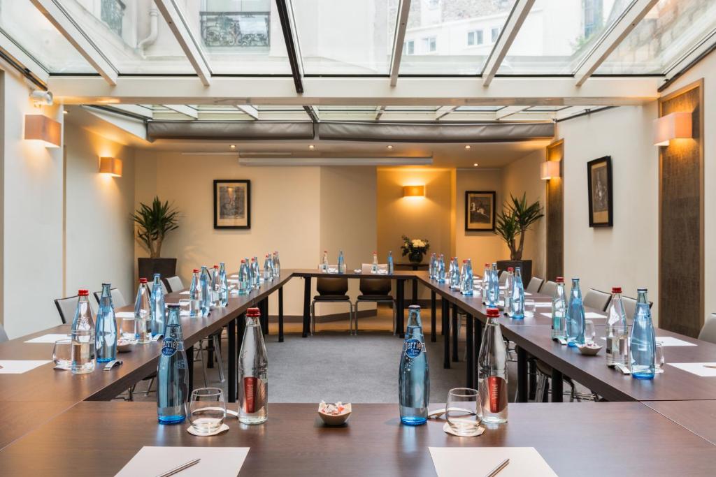 a large room with a long table with glasses at Hôtel La Bourdonnais by Inwood Hotels in Paris