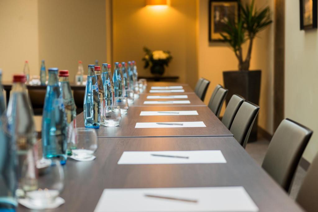 a long table with glasses and napkins on it at Hôtel La Bourdonnais by Inwood Hotels in Paris