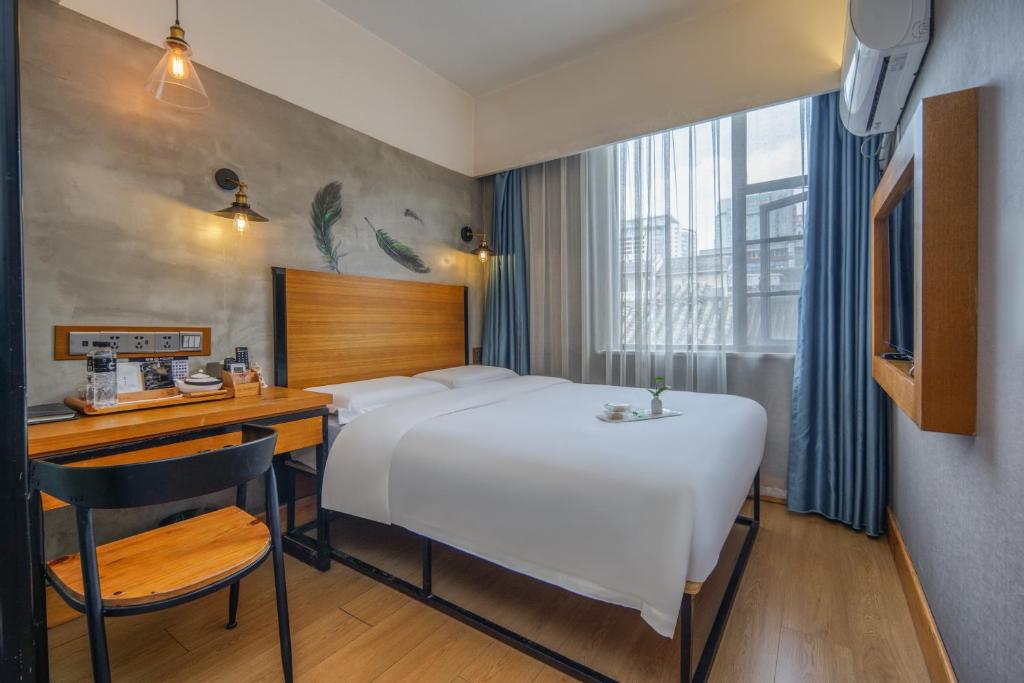 Postel nebo postele na pokoji v ubytování Gongxili - Chujian Hotel