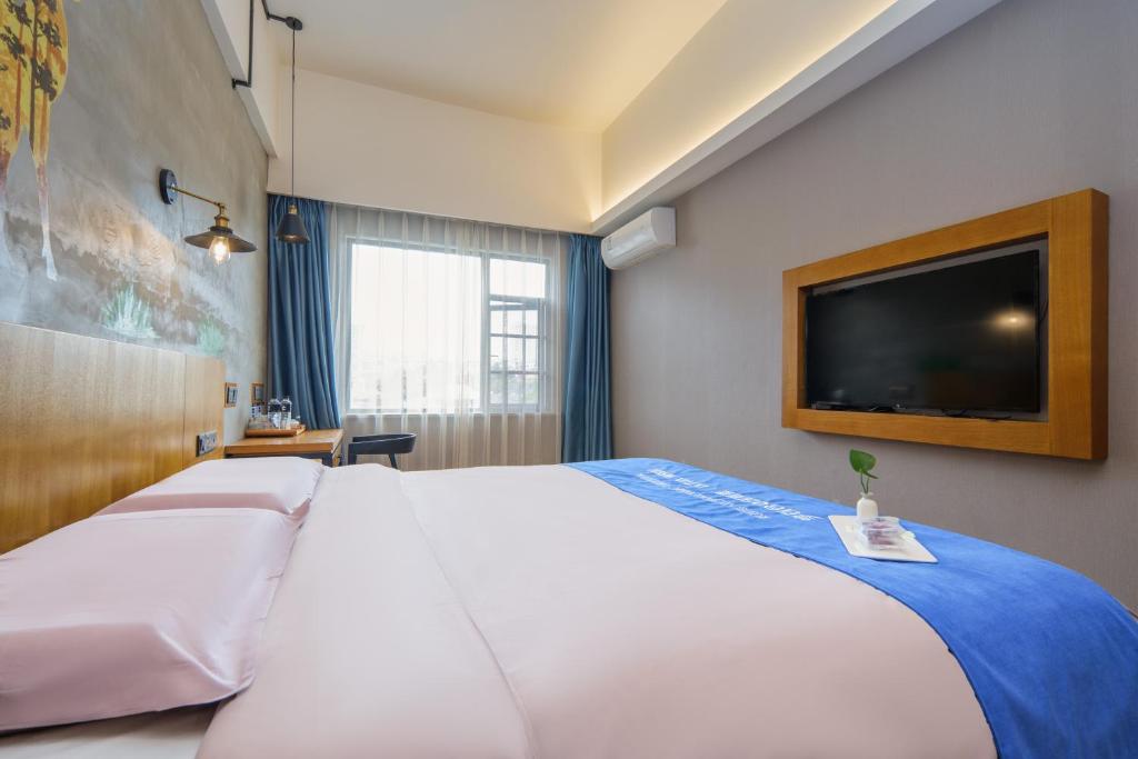 Postel nebo postele na pokoji v ubytování Gongxili - Chujian Hotel