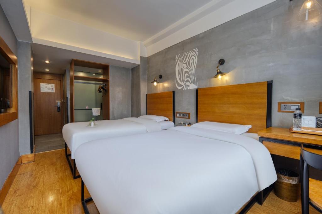 Postel nebo postele na pokoji v ubytování Gongxili - Chujian Hotel