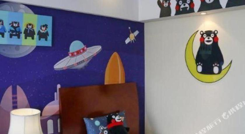 a room with a wall with planets and a bear on the moon at Argyle International Airport Hotel Shanghai in Shanghai