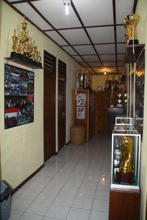 a hallway with a room with trophies on the wall at Homestay Galpera Papua in Jayapura