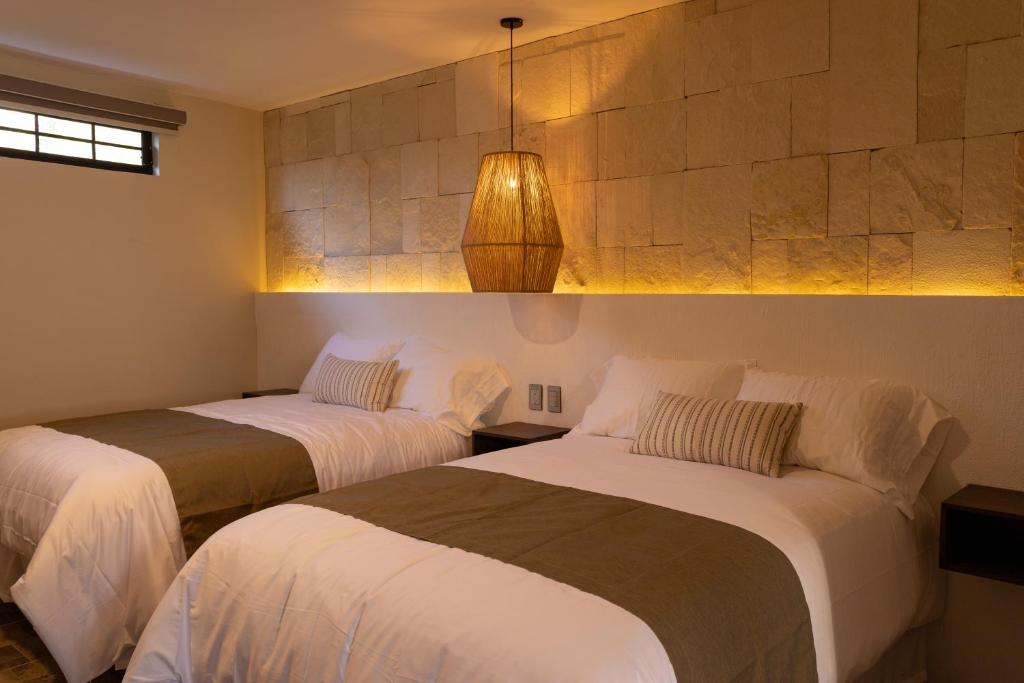 Postel nebo postele na pokoji v ubytování Traspatio Hotel Boutique