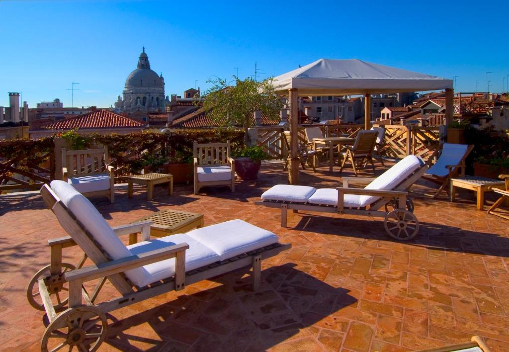 a couple of lounge chairs sitting on a patio at Hotel Saturnia &amp; International in Venice