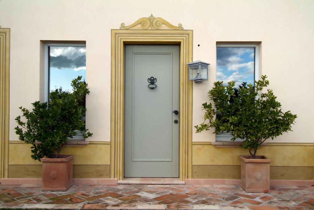a front door of a house with two potted plants at Casa Pazzi in Grottammare
