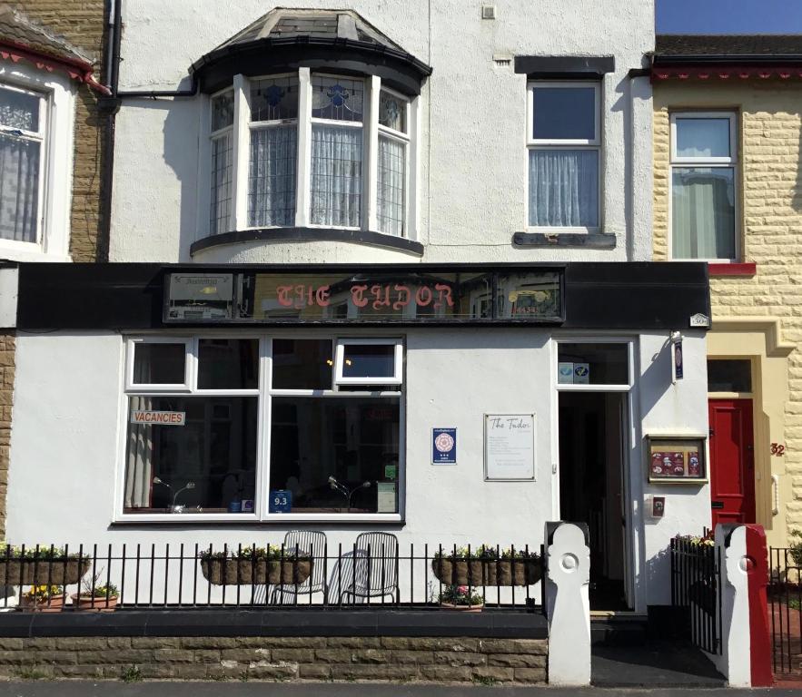 a white building with a table and chairs in it at The Tudor in Blackpool