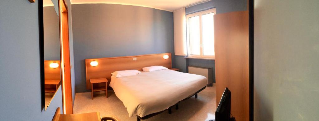 Postel nebo postele na pokoji v ubytování Hotel Monumento