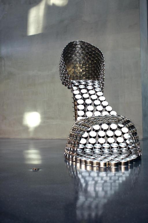 a metal chair sitting on top of a table at Troia Design Hotel in Troia