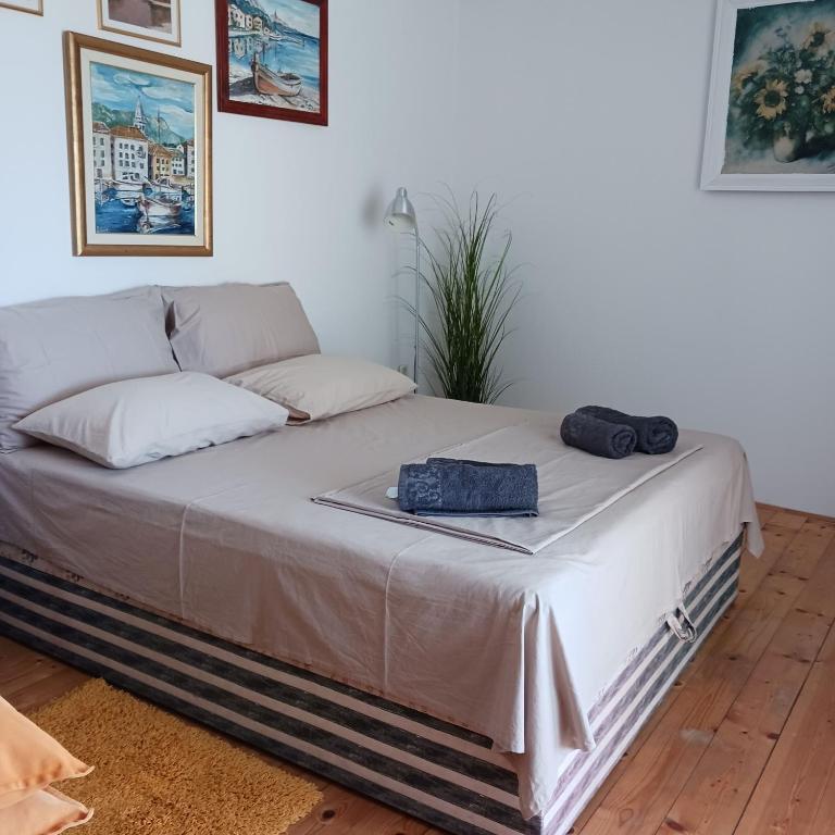 a bed with two bags sitting on top of it at Apartments Elena & Damir in Vis