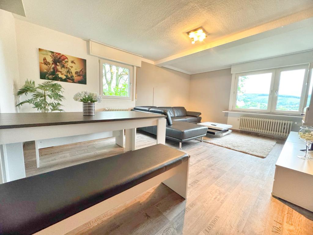 a living room with a couch and a table at 95qm Komfort & Natur Pur in Werdohl
