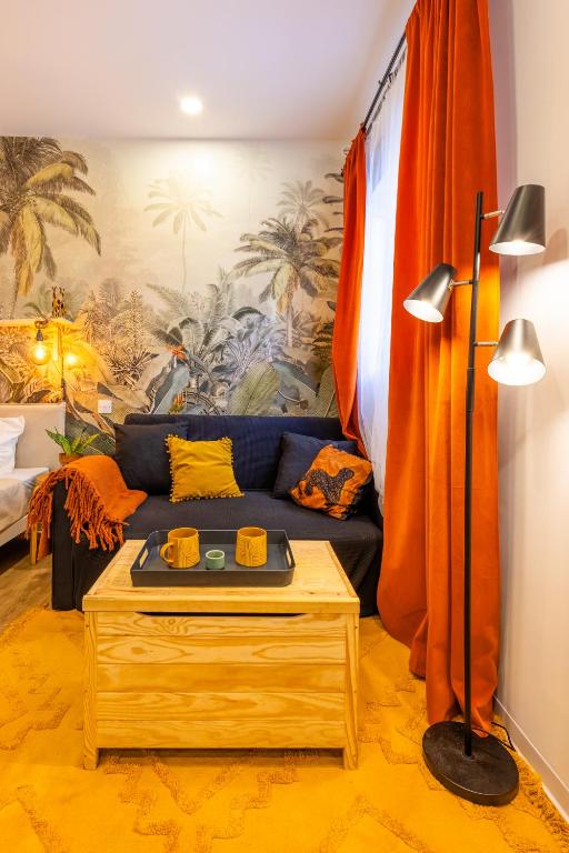 a living room with a couch and a table at Smart Studio, AC ,Fast Wi-Fi & Walk to Marina by QuickTrips in Taʼ Xbiex