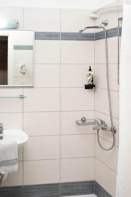 a bathroom with a shower and a sink at Konstantinos Hotel & Apartments 2 in Nydri