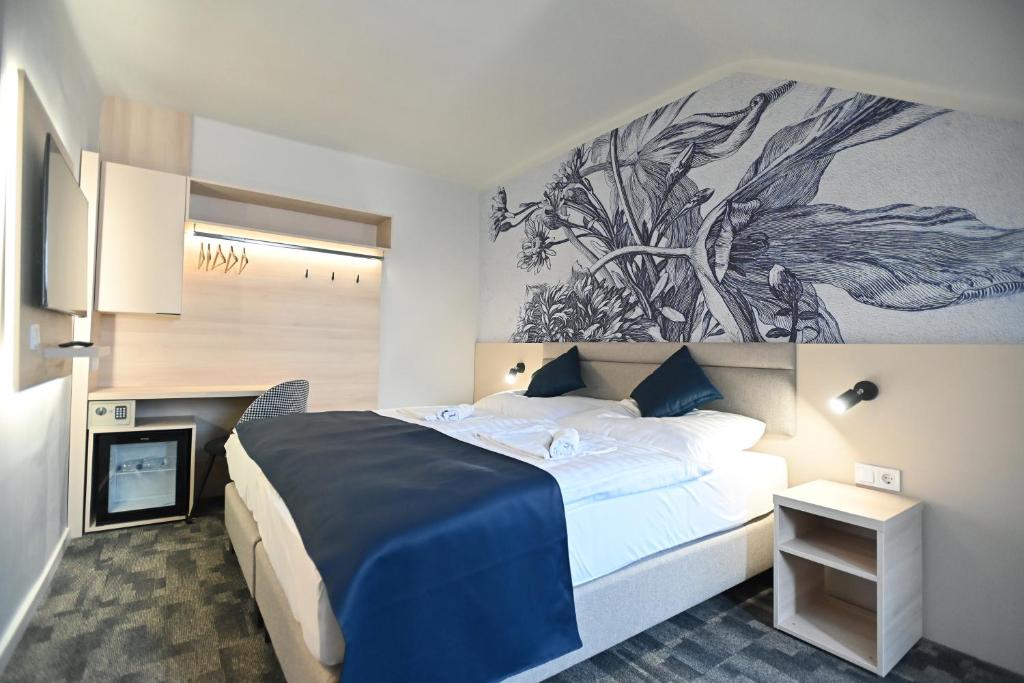 Postel nebo postele na pokoji v ubytování Hotel Merlot