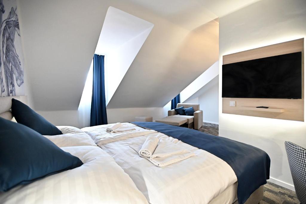 Postel nebo postele na pokoji v ubytování Hotel Merlot