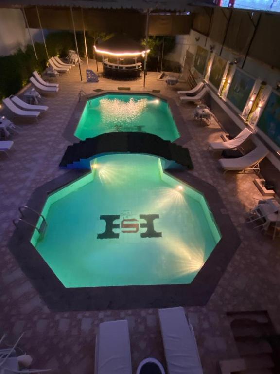 an overhead view of a swimming pool at night at Shady Hotel Luxor in Luxor