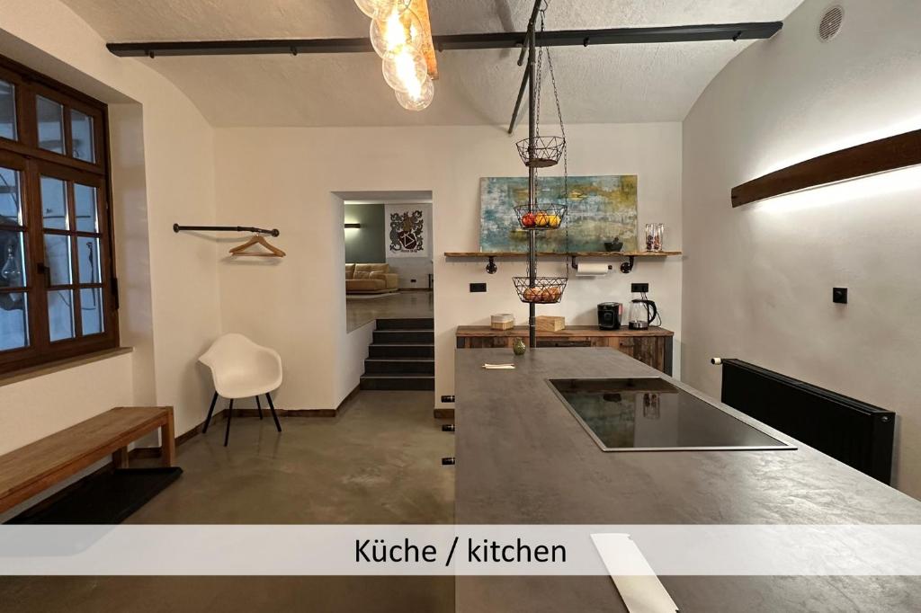 a kitchen with a island in a room at KORN14 Loft - Parken, Küche in Freinsheim