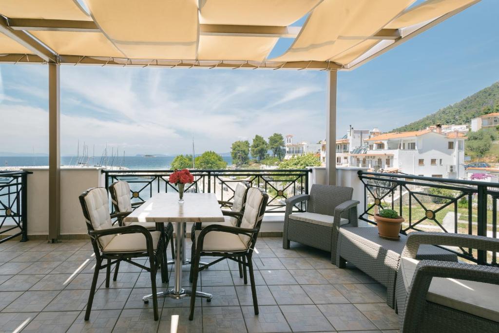 a table and chairs on a balcony with a view at Anna Maria - Vanessa Apartments in Neo Klima