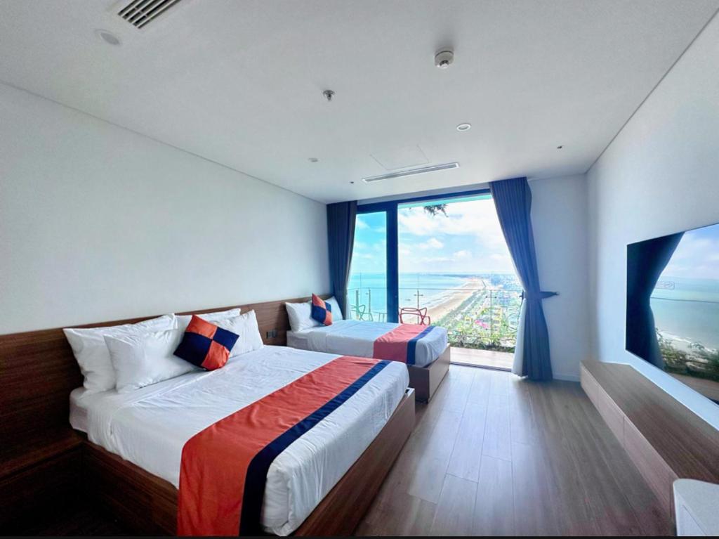 Ένα ή περισσότερα κρεβάτια σε δωμάτιο στο Flamingo Ibiza Hai Tien Luxury Resort