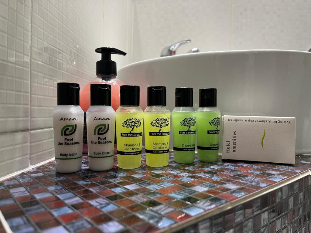 a group of four bottles of cleaning products on a bathroom counter at Maniatis Garden in Achladies