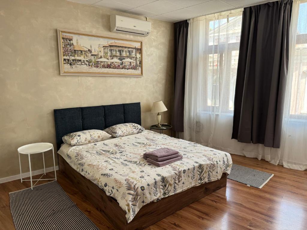 a bedroom with a bed and a window with curtains at habitat Heart of Ruse Apartment in Ruse
