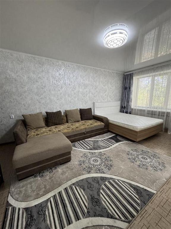 a living room with a couch and a rug at Однокомнатная Квартира 3 in Balqash