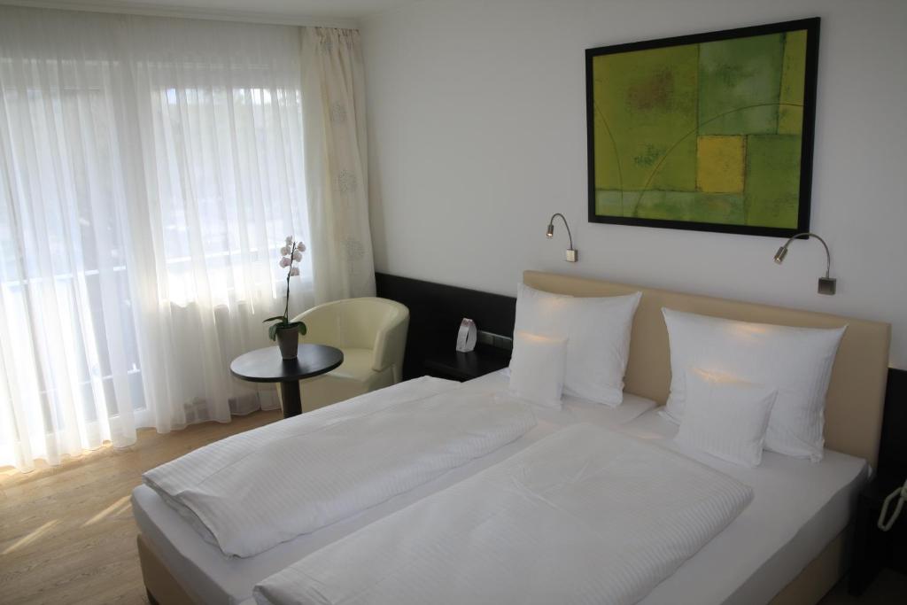 Postel nebo postele na pokoji v ubytování Seehotel Lilly