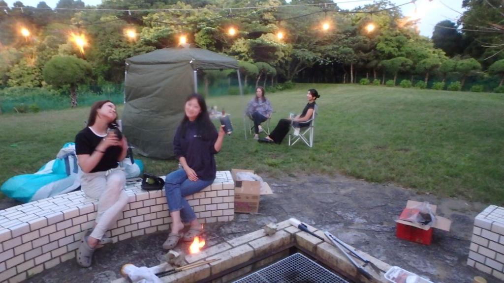 a group of women sitting on a brick wall at Isumi seishinso - Vacation STAY 84726v in Isumi
