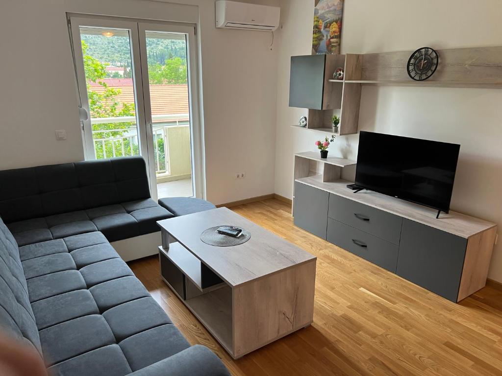 a living room with a couch and a flat screen tv at Apartment Ljalja 2 in Mostar