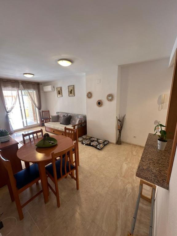 a living room with a table and chairs and a couch at Isla Park, Your Vacation Home! in Oropesa del Mar